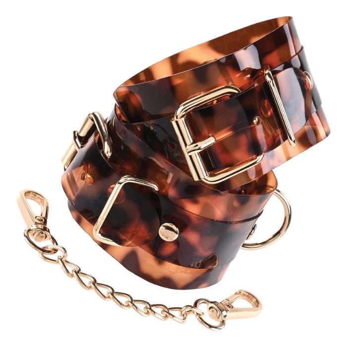 Skillfully designed for a sexy and secure hold, the Amber Handcuffs add a sophisticated touch to this bondage essential. Perfect for combining with the rest of the Amber collection, these handcuffs offer a ravishing way to relinquish control with gold-plated accents and translucent tortoiseshell-inspired material.