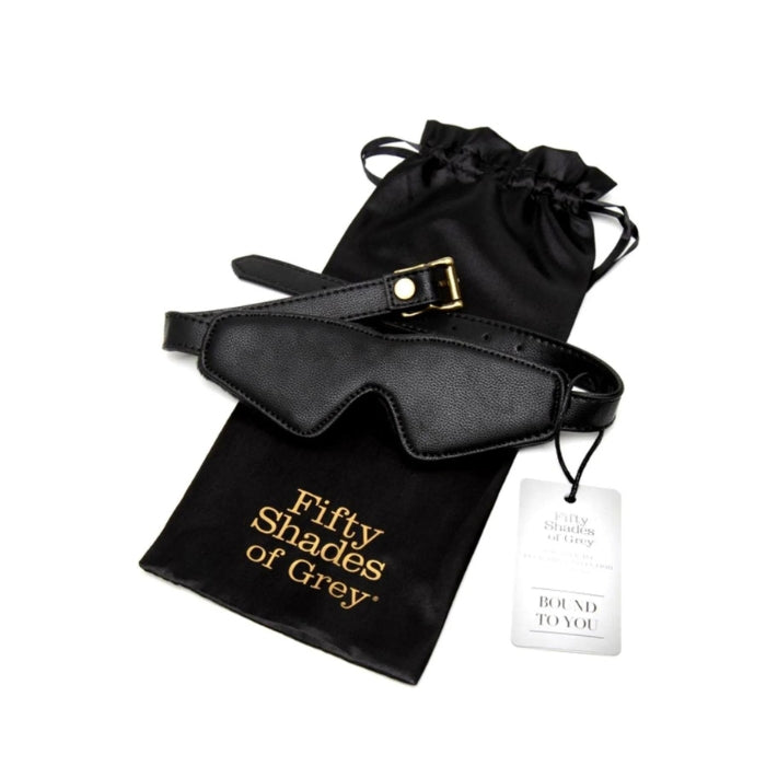 Fifty Shades of Grey Blindfold - Bound to You Black. Perfect for couples who want to introduce light bondage play and excitement to the bedroom. Heighten your senses and enhance sensory anticipation with these sensual and effective bedroom bondage accessories. Comes with a Fifty Shades of Grey bag to keep safe.