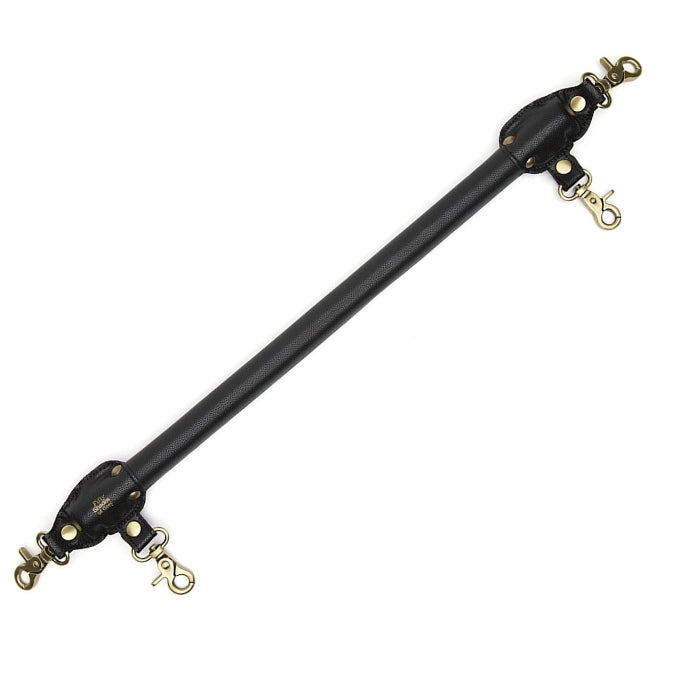 Fifty Shades of Grey Spreader Bar - Bound to You Black is a lightweight, durable and strong 50,8 cm handcrafted faux leather spreader bar with antique gold hardware. This cleverly designed bar has 4 swivel lobster clasps and is compatible with the Bound to You wrist and ankle cuffs.