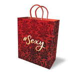 Want to make a statement to the one you love.. Or the one you would like to love? Wrap their next gift in our #Sexy gift bag. Our gift bags are high quality bags made of thick, sturdy cardstock paper with elegant woven handles. This 10-inch gift bag has a red background with dark red patterns on and gold metallic stamped "#Sexy" on front and back.