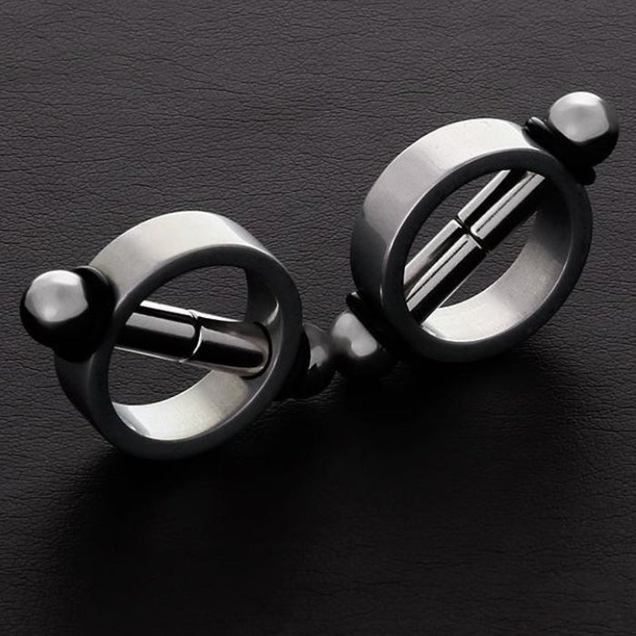 These magnetic nipple clamps are great for women and men during bondage and fetish play (BDSM) as they cause pleasant sore nipples. The aluminum ring has two magnetic rods that can be separated and slid back to hold the nipple firmly. Diameter: 3.1cm, Width: 4.9, Height: 1 cm.