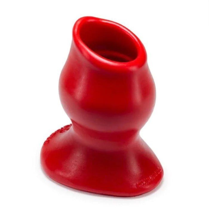 Hollow silicone butt plug allows anal play to continue longer. Features a smooth inner chamber with ripples and welts. At the tip of the plug, the walls are thin with a rolled lip. Medium size measures 4.5 in. long, 3.5 in. usable, with an inside diameter of 1.5 in.