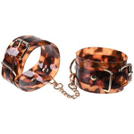 Skillfully designed for a sexy and secure hold, the Amber Handcuffs add a sophisticated touch to this bondage essential. Perfect for combining with the rest of the Amber collection, these handcuffs offer a ravishing way to relinquish control with gold-plated accents and translucent tortoiseshell-inspired material.