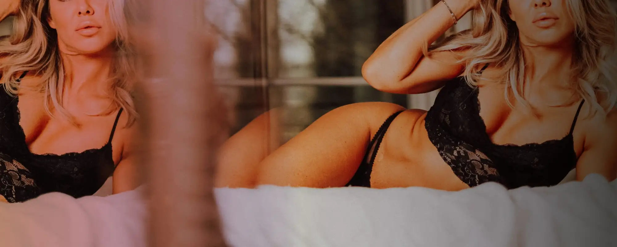 A woman in black lingerie reclines against a dark background, her form softly illuminated by dramatic lighting.