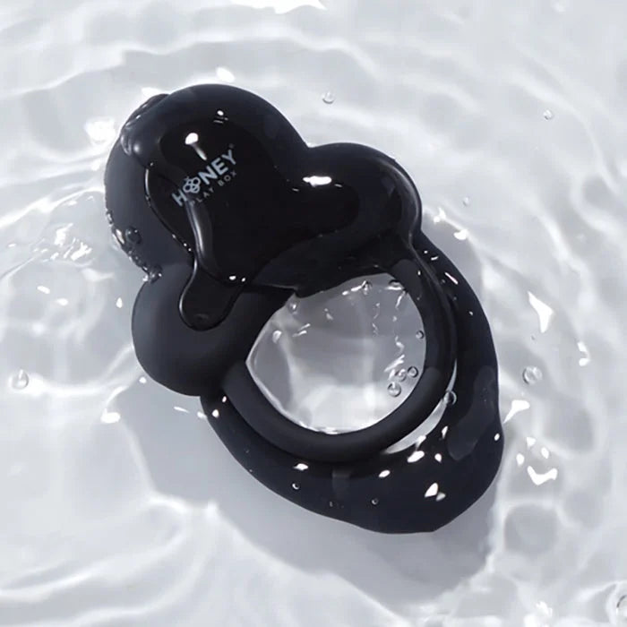 Black glossy silicone vibrating double cock ring with heart top and honey play box logo for erection firmness and thrust count