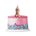 A metallic pink rose gold balloon shaped penis candle on a pink frosted cake from lady jane adult shop
