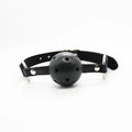 Black leather gag with spherical perforated mouthpiece and silver metal hardware from everything bondage 12 piece kit with cuffs faux fur lining
