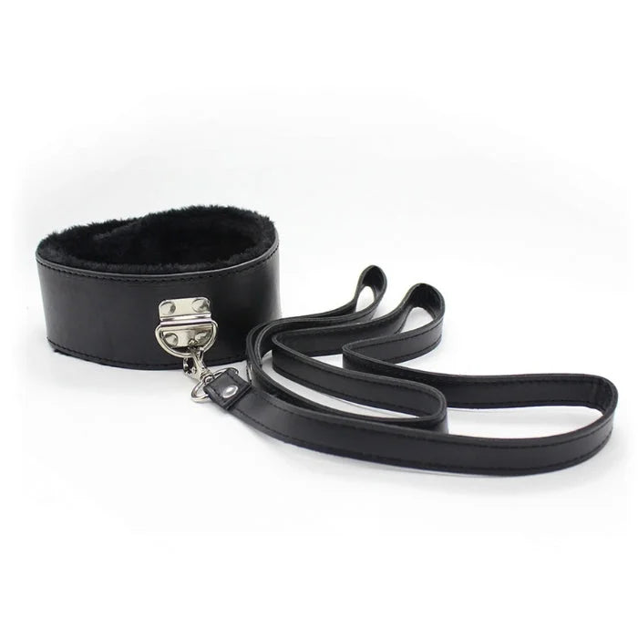 Black leather collar with plush faux fur lined interior and silver metal clasp attached to matching leash in everything bondage kit