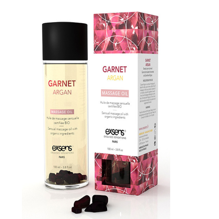 Exsens garnet massage oil 100ml in a clear glass bottle with argan oil and garnet elements in golden-yellow liquid
