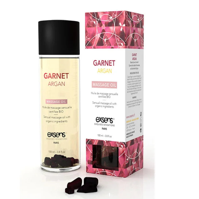 Exsens garnet massage oil 100ml in a clear glass bottle with argan oil and garnet elements in golden-yellow liquid