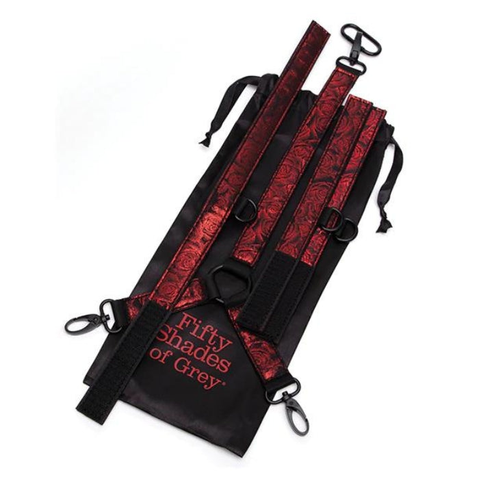 Made with soft padding in a beautiful faux leather, rose-patterned, black-and-red colorway. Beautifully crafted with padding and a reversible design, these cuffs and collar are fully adjustable via a six-hole buckle to give you the perfect fit. Thanks to a connecting chain with quick-release clips, your restraint adventures are both secure and safe. What's more, a D-ring to each wrist cuff means adding other restraints is easy.