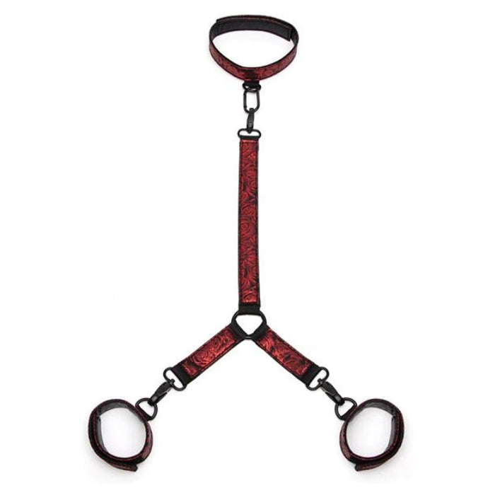 Made with soft padding in a beautiful faux leather, rose-patterned, black-and-red colorway. Beautifully crafted with padding and a reversible design, these cuffs and collar are fully adjustable via a six-hole buckle to give you the perfect fit. Thanks to a connecting chain with quick-release clips, your restraint adventures are both secure and safe. What's more, a D-ring to each wrist cuff means adding other restraints is easy.