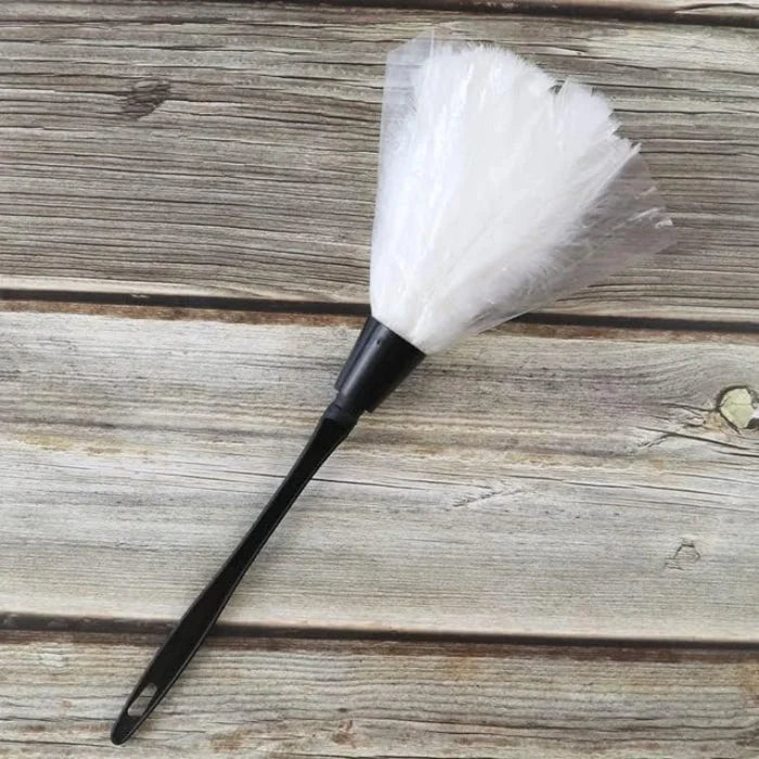 White novelty maid feather duster with black handle for role play