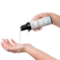 A sleek white bottle of orgie aqua all natural water based long lasting lube pours clear liquid into a hand for sensitive skin