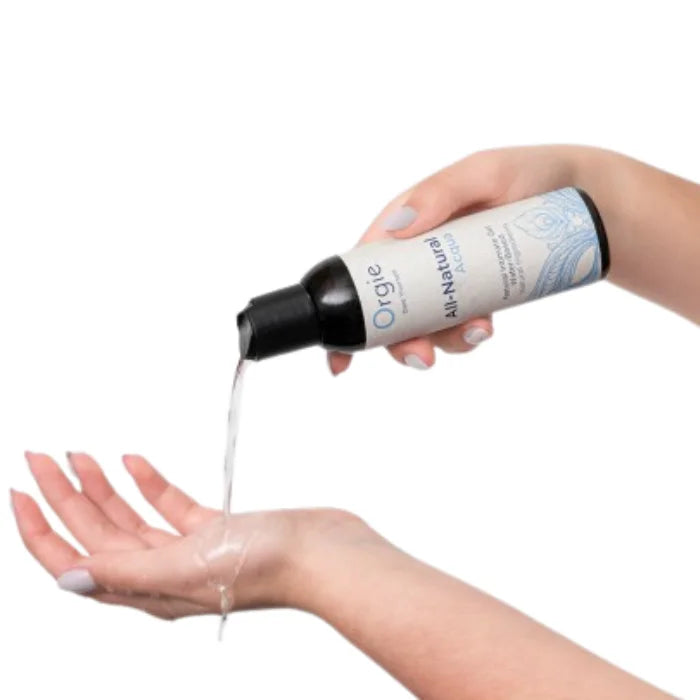 A sleek white bottle of orgie aqua all natural water based long lasting lube pours clear liquid into a hand for sensitive skin