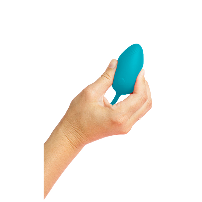 Hand holding teal silicone Odetta remote controlled egg vibrator