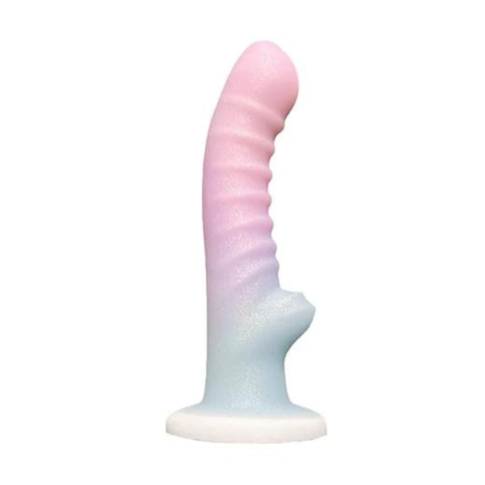 The Cotton Candy Dildo is 6.5 inches of sensory goodness. Contoured and curved in order to reach and massage your G-Spot or P-Spot and wake up nerve endings all along the vaginal or anal canal. Glitter sparkles throughout the dreamy gradient of pastel colors that run the length of the shaft. Attach the strong suction cup base to any hard surface or slip this dreamy dildo into a harness of your choice.