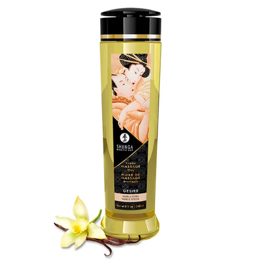 A tall slender bottle of shunga desire vanilla massage oil with black cap gold trim and illustrated traditional label