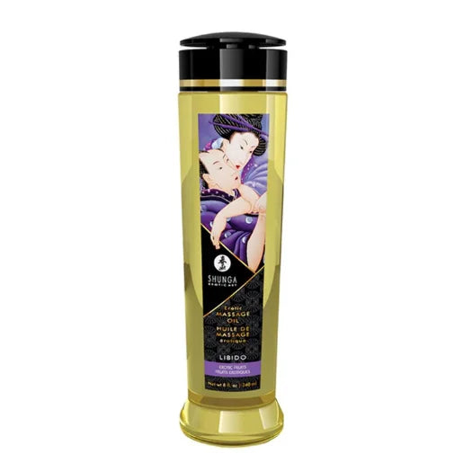Golden-yellow shunga libido exotic fruits massage oil in a transparent bottle with black cap and illustrated couple label