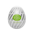 White egg-shaped Tenga easy beat brush with glossy surface, silver stripes, body safe elastomer, and pre lubricated design