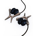 Silver-toned branch-like vibrating nipple clamps with glossy black beads for sensation play with vibrating units