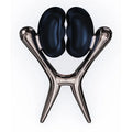 Black glossy bean-shaped vibrating nipple clamps on a sleek metallic silver stand for sensation play with vibrating units
