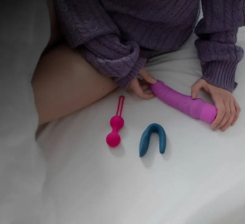 Pink silicone dildo with textured grip and rounded head