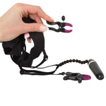 Bad Kitty Spreader String with Bullet Vibrator! A black g-string with clamps for the labia to expose the clitoris, the string also has a small vibrator that is attached to the stimulating pearls for the clitoris. You can adjust the intensity of the clamps with the adjusting screws. Total length 69 cm long (stretchable and adjustable), length of each clamp 6 cm. For extra stimulation use a clitoral gel.