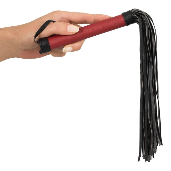 Red handled flogger with soft black tassels.