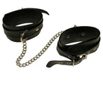 Black leather-like adjustable ankle cuffs with silver joining chain.
