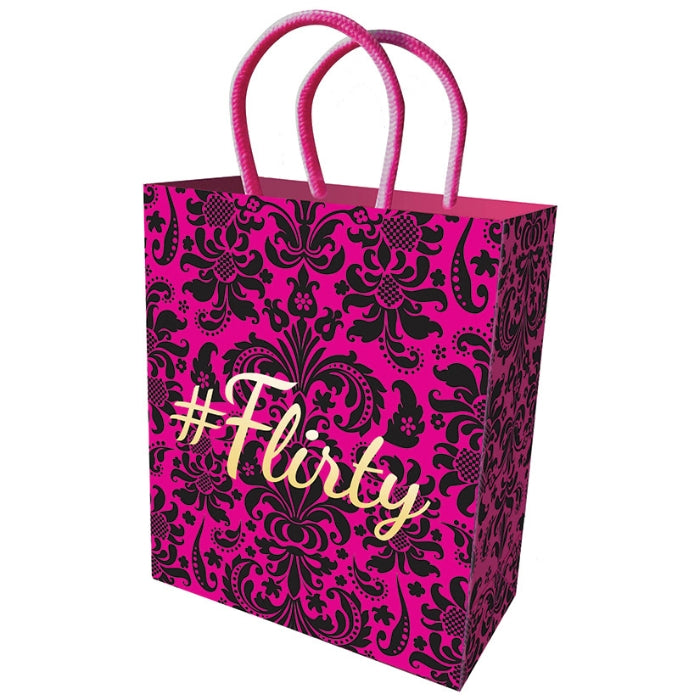 pink 8 by 5.5 inch gift bag with velvet-like floral pattern. Has an imprinted gold "Flirty" foil stamp.
