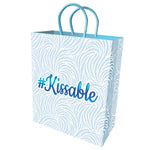 10-inch gift bag has a white background with pastel blue flocking and matching metallic stamped #Kissable on the front and back.