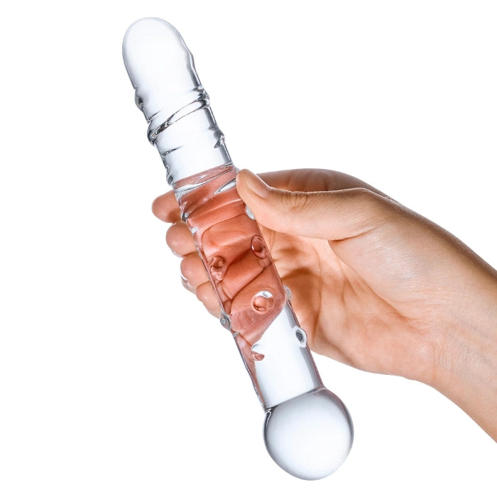 Glas Callisto Clear Glass 7 inch Dildo with ridges and nubs along the shaft. In hand to show transparency and size.