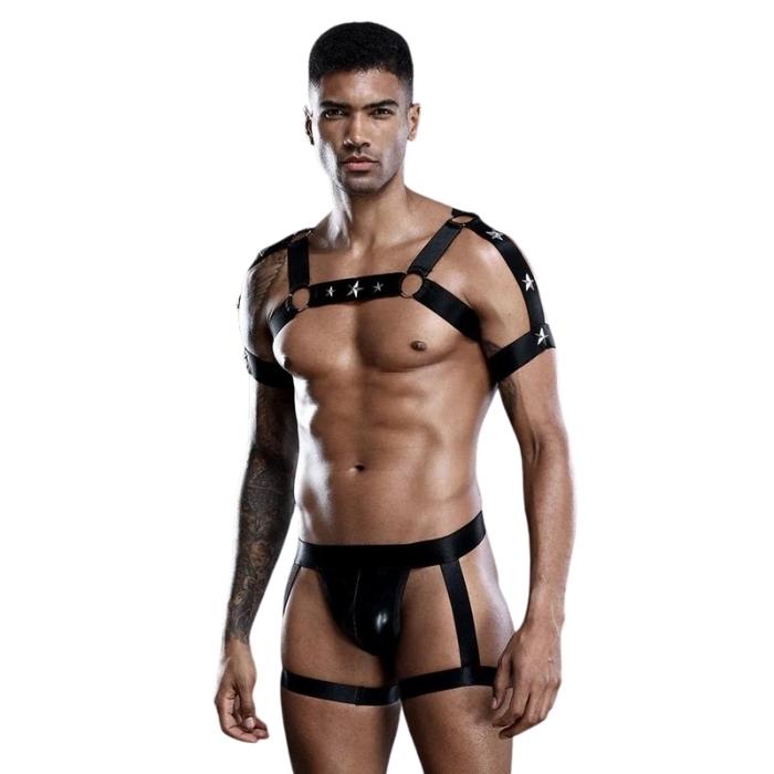 Outfit includes chest harness with star details and latex look underwear with leg garters.