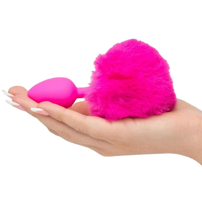 Neon Bunny Tail Butt Plug, comes in a gorgeous neon pink. Made from super-smooth flexible silicone, the tapered tip inserts easily and the slender shape provides exciting pleasure. The fluffy Bunny tail ensures it won't slip too far inside lying flat on hand to show size.